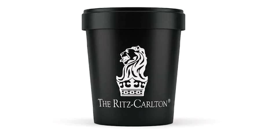 Matte black private-label gelato tub printed with THE RITZ-CARLTON crest